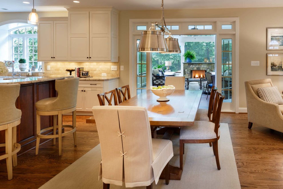 Inspiration for a large transitional medium tone wood floor and brown floor eat-in kitchen remodel in DC Metro with a farmhouse sink, white cabinets, beige backsplash, stainless steel appliances and beige countertops