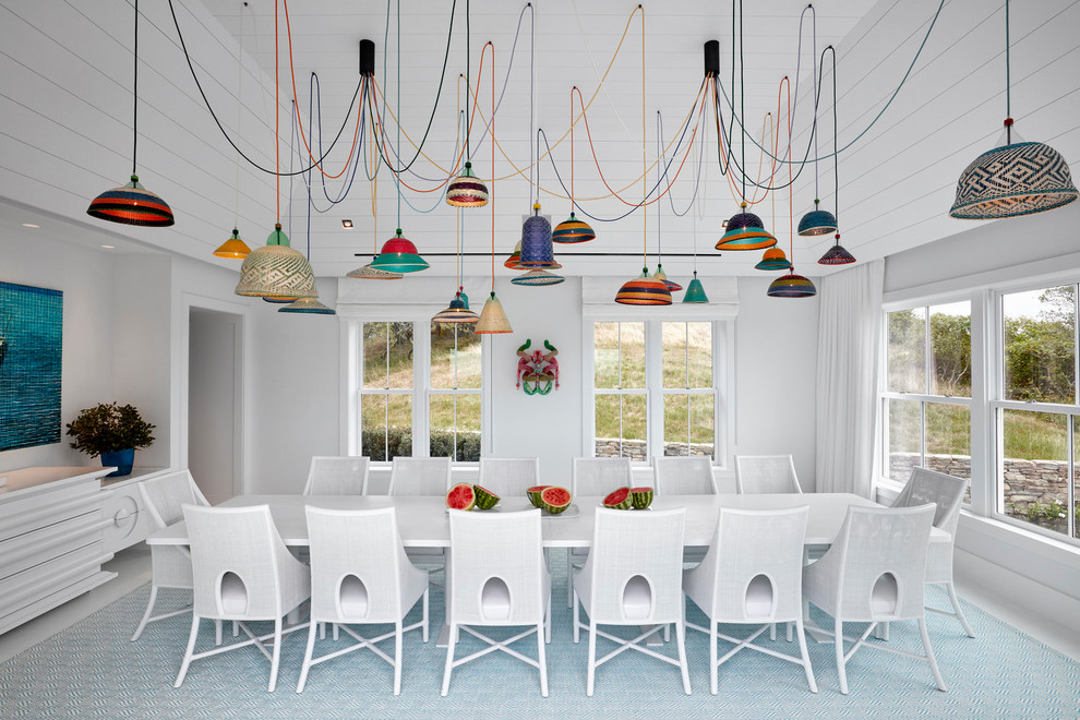 Beach style separate dining room in New York with white walls, carpet and multi-coloured floor.