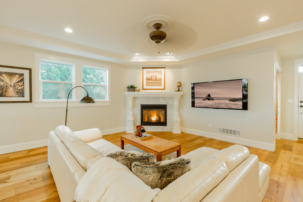 Inspiration for a traditional open concept living room in Vancouver with beige walls, light hardwood floors, a wall-mounted tv and a ribbon fireplace.