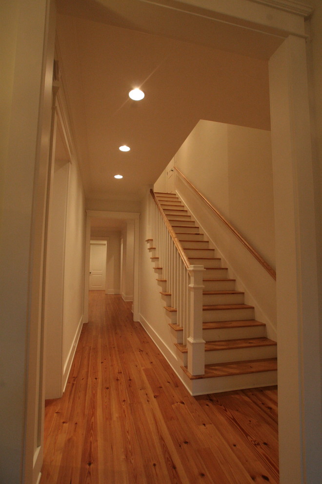 Photo of a mid-sized traditional wood straight staircase in Other with wood risers.