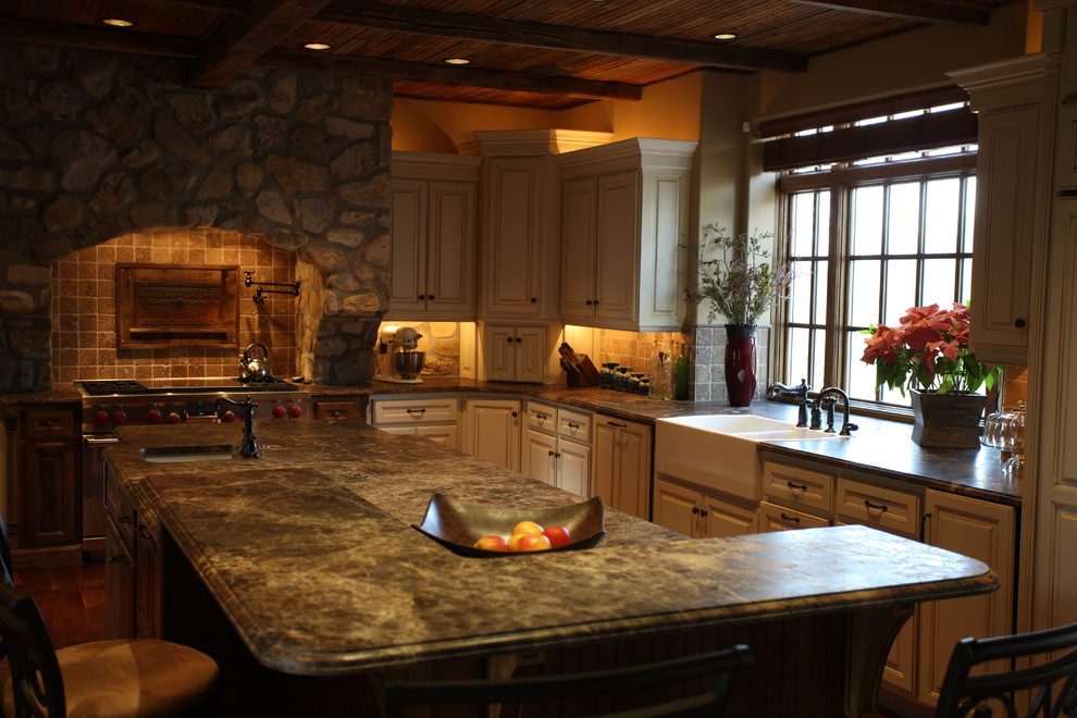 Inspiration for a large rustic l-shaped medium tone wood floor and brown floor open concept kitchen remodel with an undermount sink, white cabinets, granite countertops, brown backsplash, stone tile backsplash, stainless steel appliances and an island