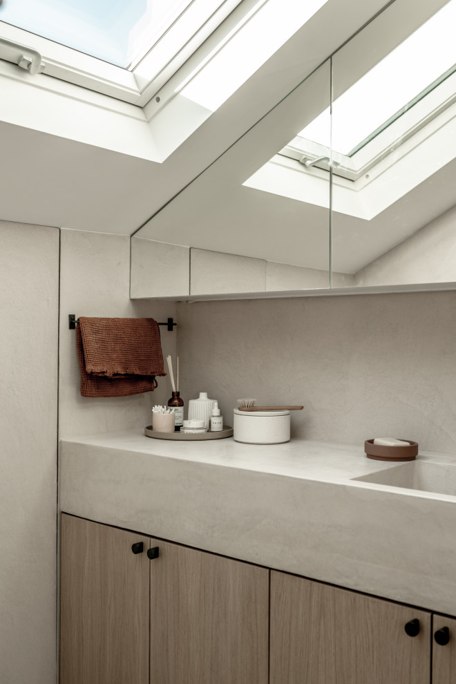 This is an example of a small modern master bathroom in London with beaded inset cabinets, medium wood cabinets, concrete benchtops and pink benchtops.