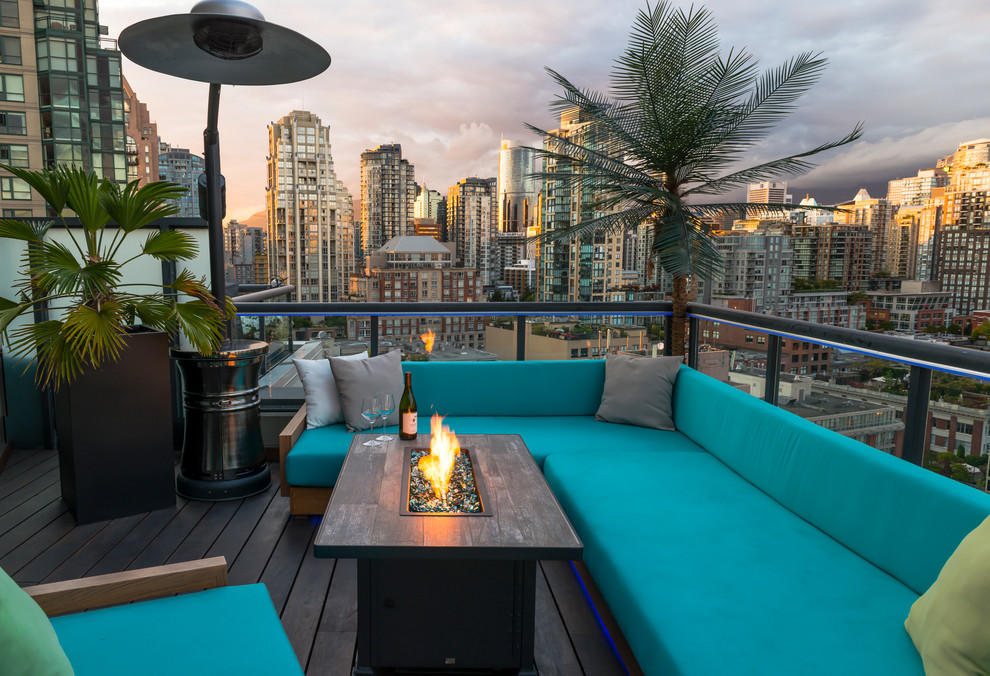 This is an example of a small tropical rooftop deck in Vancouver.