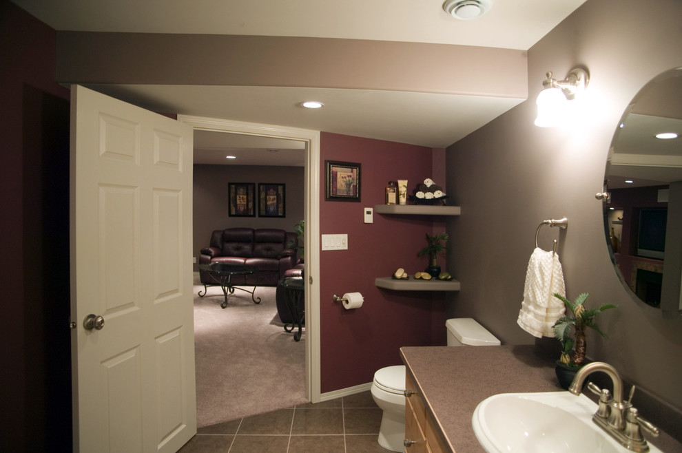 Photo of a large mediterranean 3/4 bathroom in Other with light wood cabinets, brown tile, ceramic tile, purple walls, ceramic floors, a drop-in sink and laminate benchtops.
