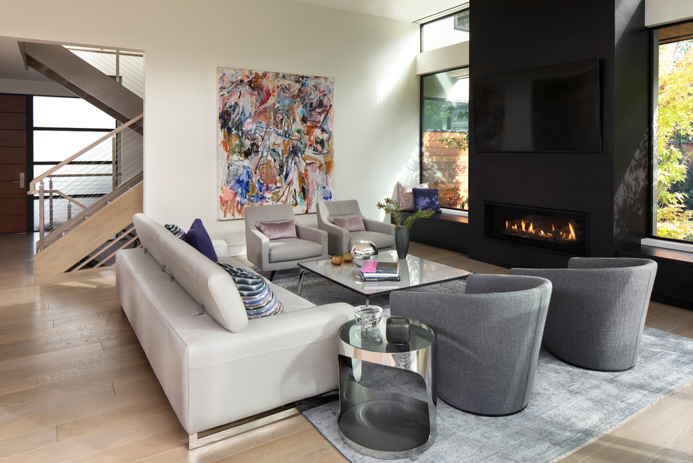 Inspiration for a contemporary open concept living room in San Francisco with white walls, light hardwood floors, a ribbon fireplace, a tile fireplace surround and a wall-mounted tv.