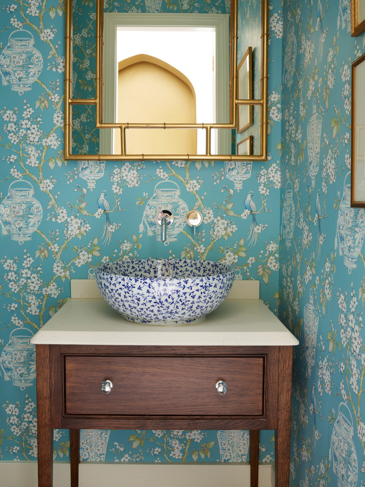 Design ideas for a small traditional powder room in London with brown cabinets, multi-coloured walls and a trough sink.