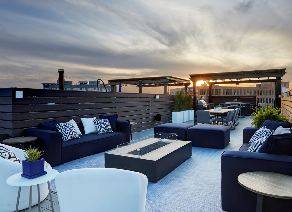 Large contemporary rooftop deck in Chicago with a fire feature and no cover.