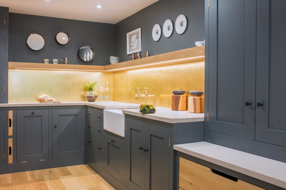 This is an example of a small industrial l-shaped separate kitchen in Other with a farmhouse sink, shaker cabinets, grey cabinets, quartz benchtops, metallic splashback, metal splashback and no island.