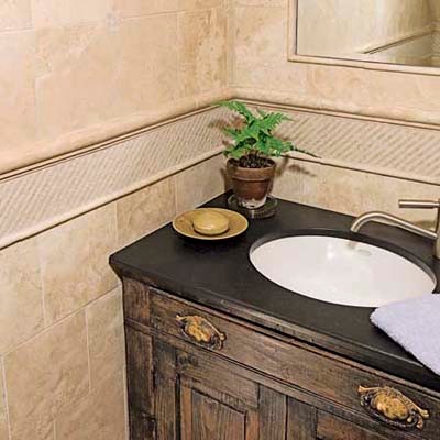 Photo of a small traditional bathroom in New York with a drop-in sink, an alcove shower and limestone floors.