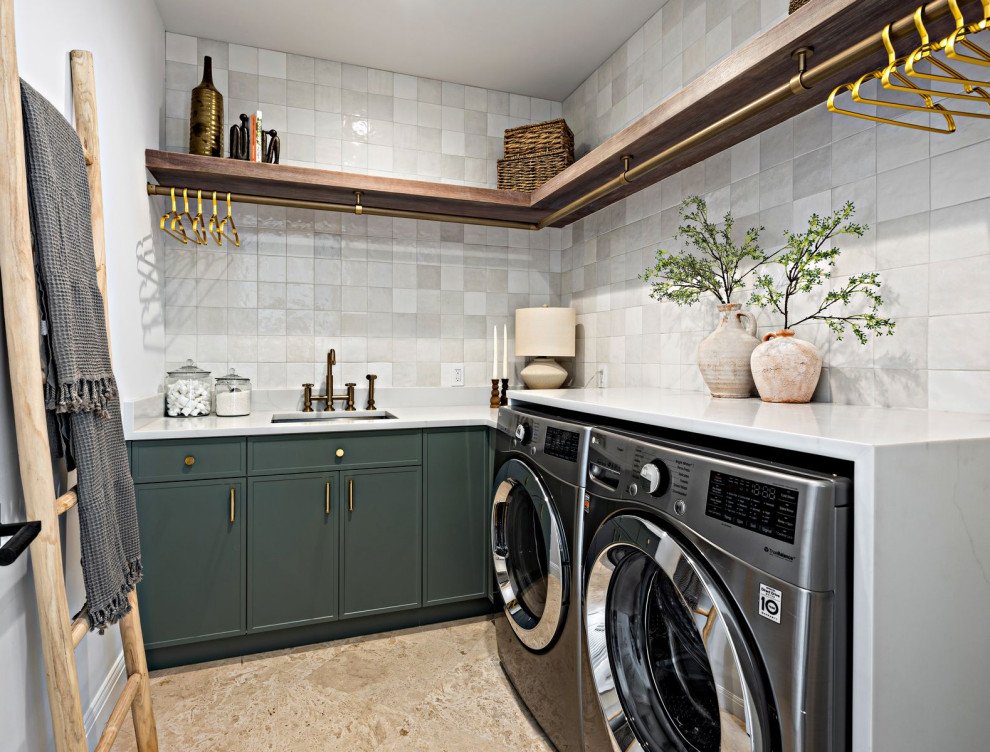 This is an example of a mediterranean l-shaped laundry room in Miami with flat-panel cabinets, green cabinets, ceramic splashback and white benchtop.