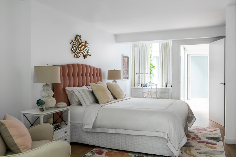 Inspiration for a mid-sized transitional bedroom in Melbourne with white walls, light hardwood floors and no fireplace.