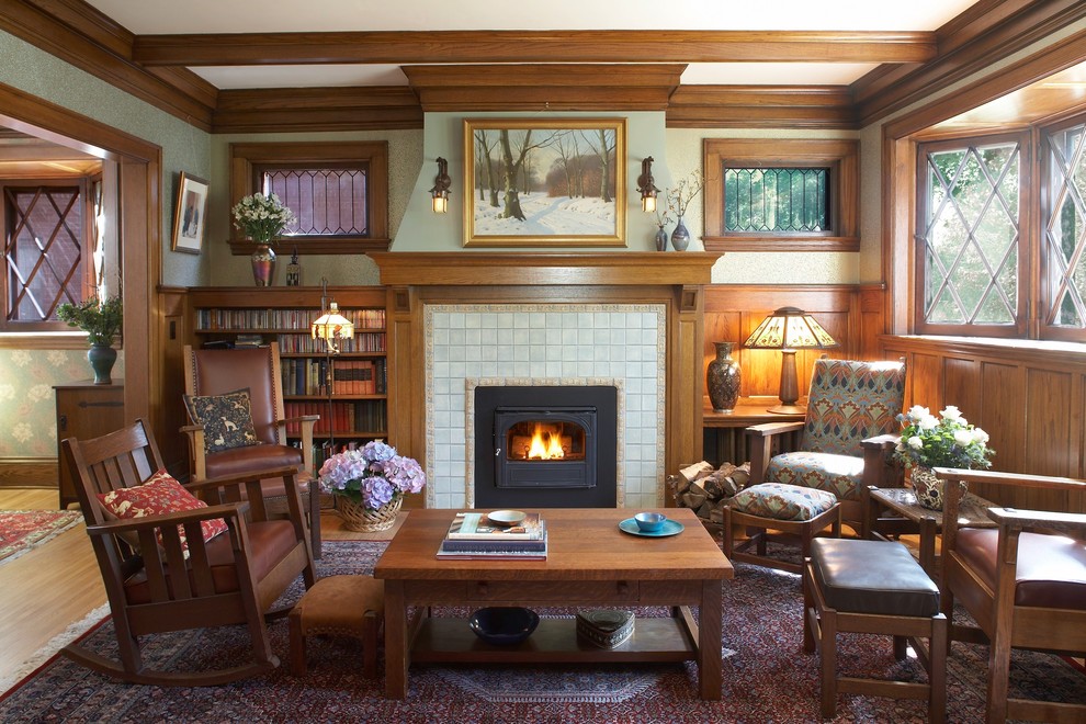 Inspiration for a mid-sized arts and crafts enclosed living room in Minneapolis with green walls, a standard fireplace, a tile fireplace surround and no tv.