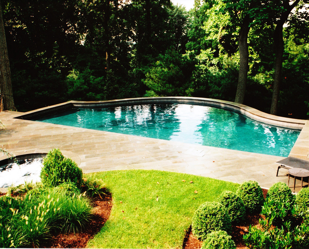 Design ideas for a large traditional backyard custom-shaped pool in Philadelphia with natural stone pavers.