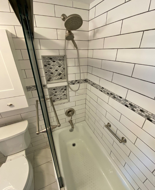 Inspiration for a small transitional 3/4 white tile and subway tile ceramic tile, white floor and single-sink alcove bathtub remodel with furniture-like cabinets, white cabinets, a two-piece toilet, white walls, an undermount sink, quartz countertops, white countertops, a niche and a freestanding vanity