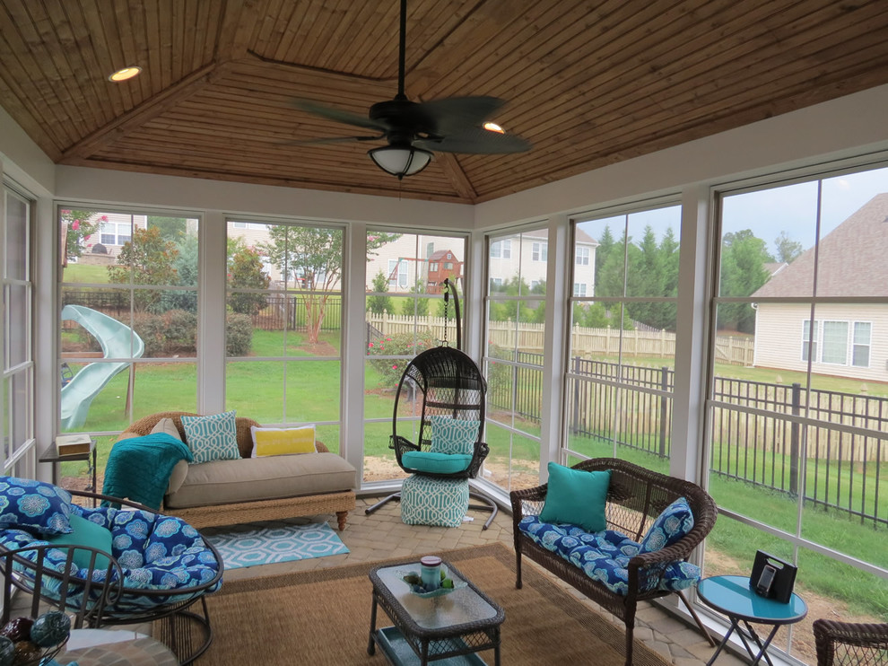 Photo of a mid-sized traditional sunroom in Charlotte with brick floors, no fireplace and a standard ceiling.