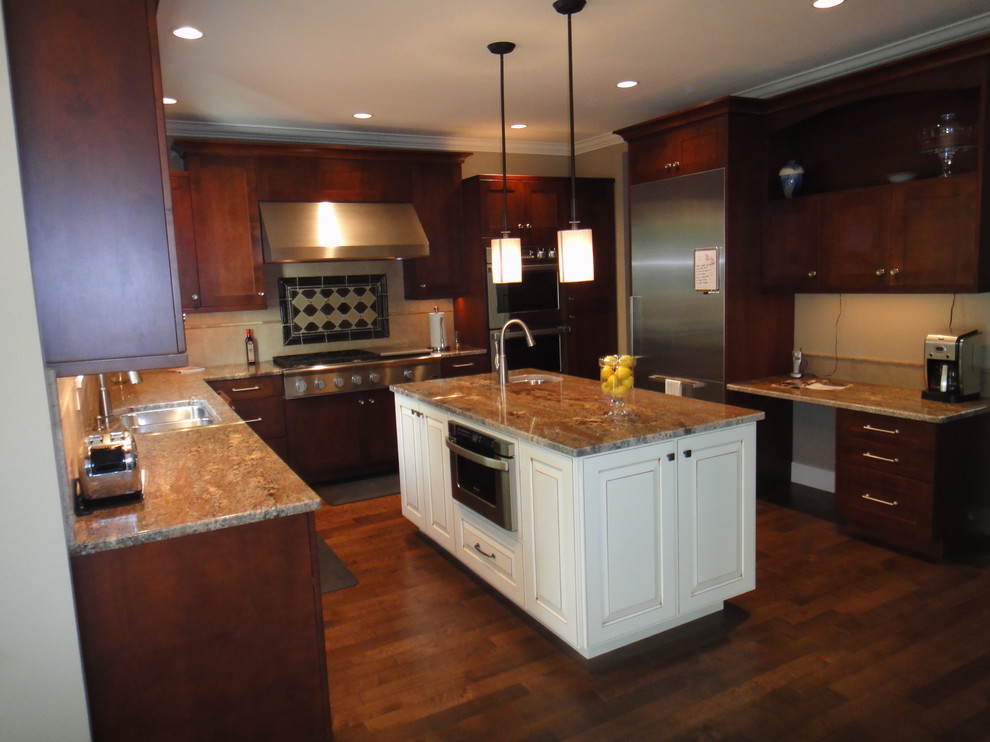 Inspiration for a large transitional u-shaped dark wood floor and brown floor enclosed kitchen remodel in Seattle with an undermount sink, shaker cabinets, dark wood cabinets, granite countertops, beige backsplash, ceramic backsplash, stainless steel appliances and an island