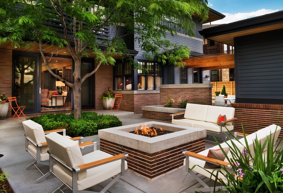 Patio - mid-sized contemporary backyard concrete patio idea in Denver with a fire pit and no cover