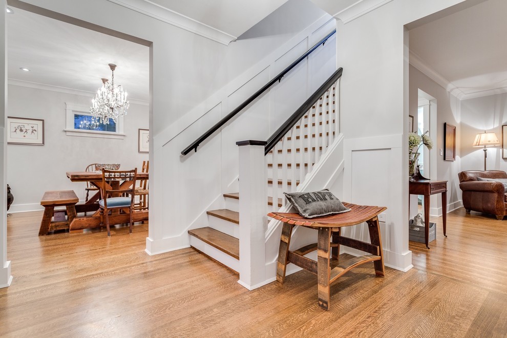 Mid-sized traditional foyer in Vancouver with medium hardwood floors, grey walls, a single front door and a white front door.