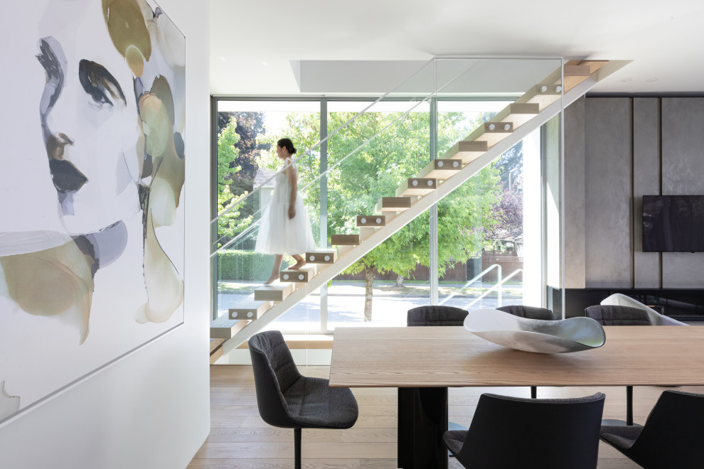 Mid-sized trendy wooden floating open and glass railing staircase photo in Vancouver