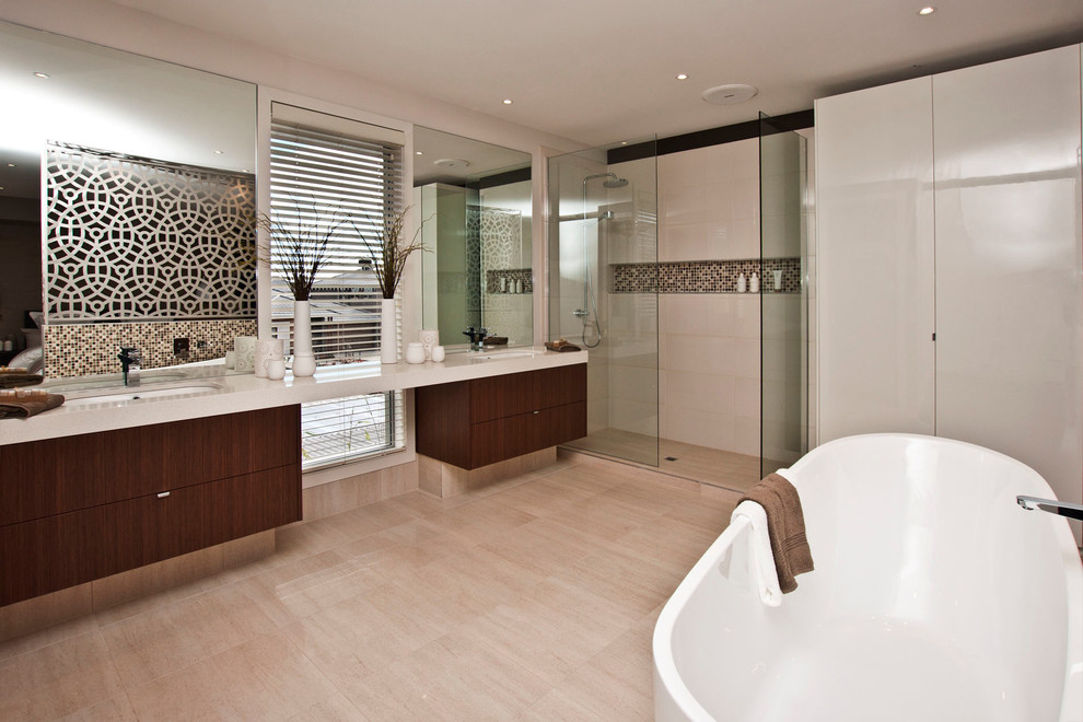 Design ideas for a large modern master bathroom in Melbourne with an integrated sink, furniture-like cabinets, medium wood cabinets, granite benchtops, a freestanding tub, a double shower, multi-coloured tile, brown walls and light hardwood floors.