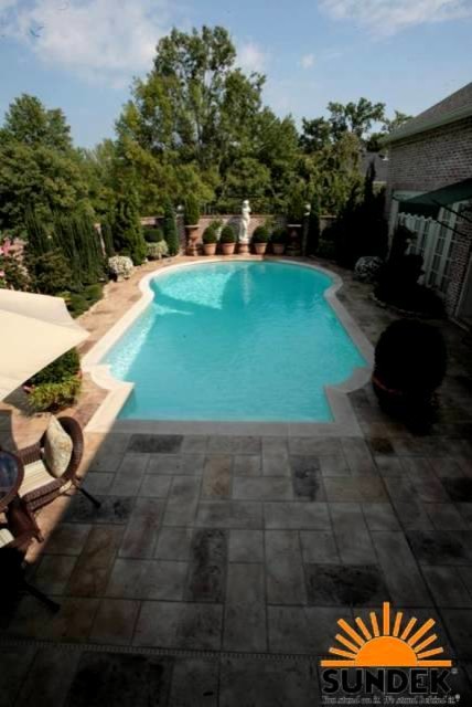 Mid-sized eclectic backyard custom-shaped aboveground pool in Nashville with stamped concrete.