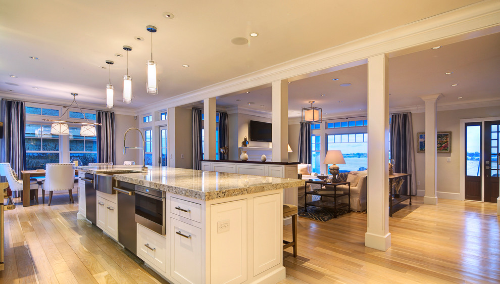 Open concept kitchen - large transitional single-wall light wood floor and beige floor open concept kitchen idea in Providence with beaded inset cabinets, white cabinets, granite countertops, an island, a farmhouse sink, beige backsplash, mosaic tile backsplash and stainless steel appliances