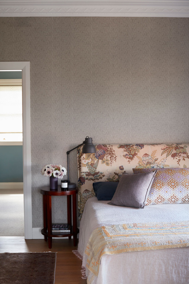 Large eclectic master bedroom in Sydney with grey walls, dark hardwood floors, no fireplace, brown floor and wallpaper.