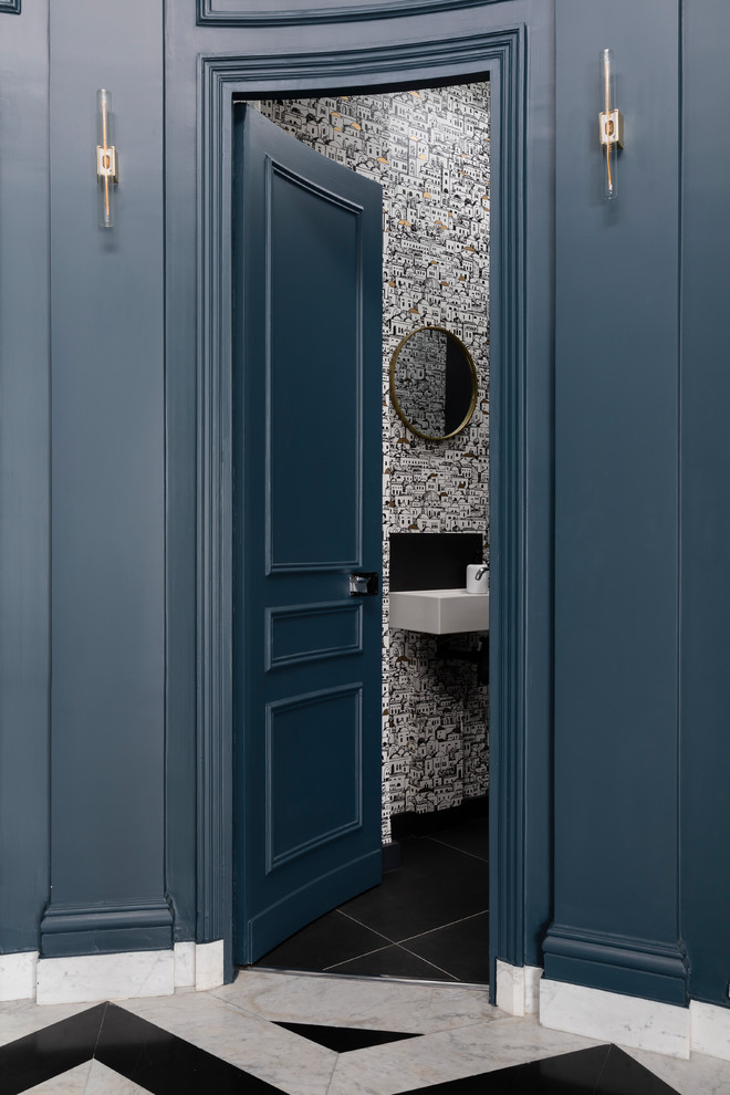 This is an example of a mid-sized contemporary powder room in Paris with a wall-mount toilet, white tile, black tile, porcelain floors, a wall-mount sink, black floor and white benchtops.