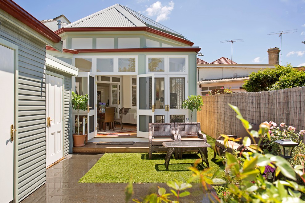 This is an example of a small traditional backyard and one-storey patio in Sydney with no cover.