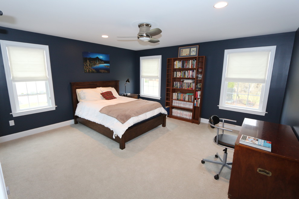 Large transitional guest bedroom in Philadelphia with blue walls and carpet.