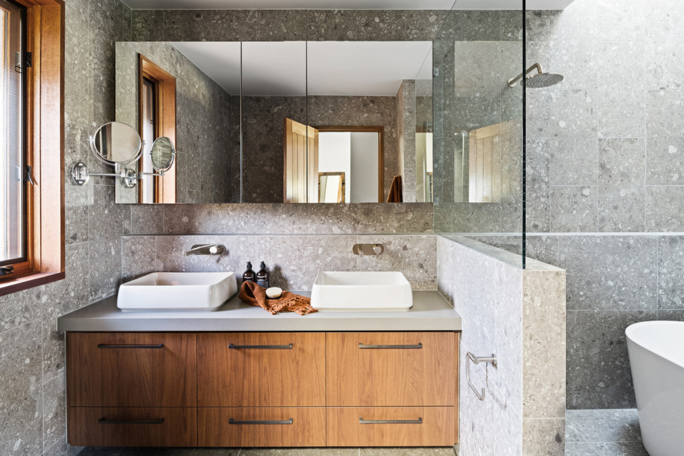 Photo of a scandinavian bathroom in Melbourne with a freestanding tub, a shower/bathtub combo, a double vanity and a built-in vanity.