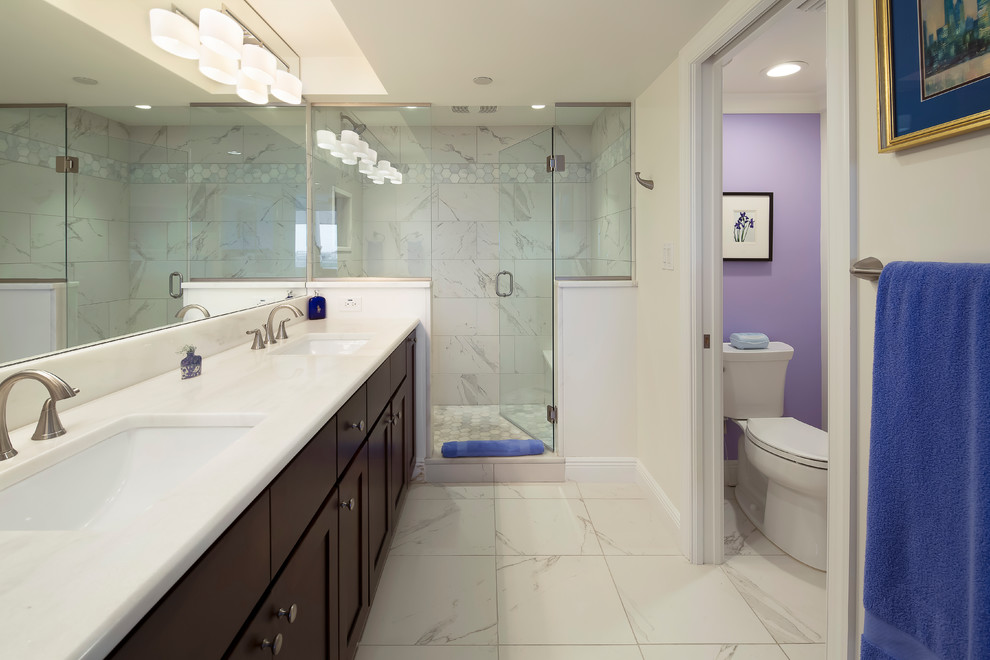 Inspiration for a transitional master bathroom in Miami with recessed-panel cabinets, brown cabinets, an alcove shower, a two-piece toilet, gray tile, white tile, white walls, an undermount sink, white floor, a hinged shower door and white benchtops.