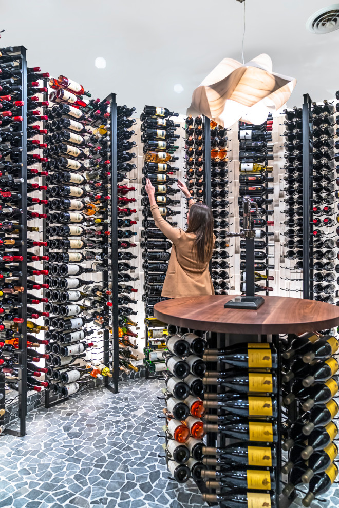 Photo of a large contemporary wine cellar in Columbus with display racks.