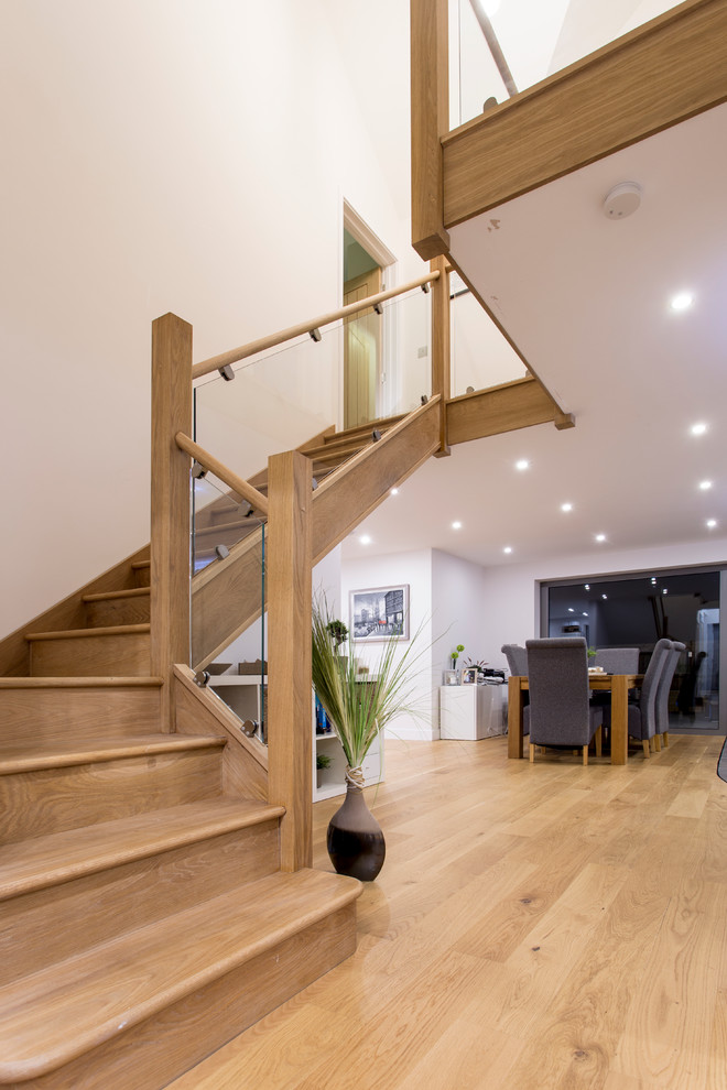 This is an example of a mid-sized contemporary wood l-shaped staircase in Oxfordshire with wood risers.