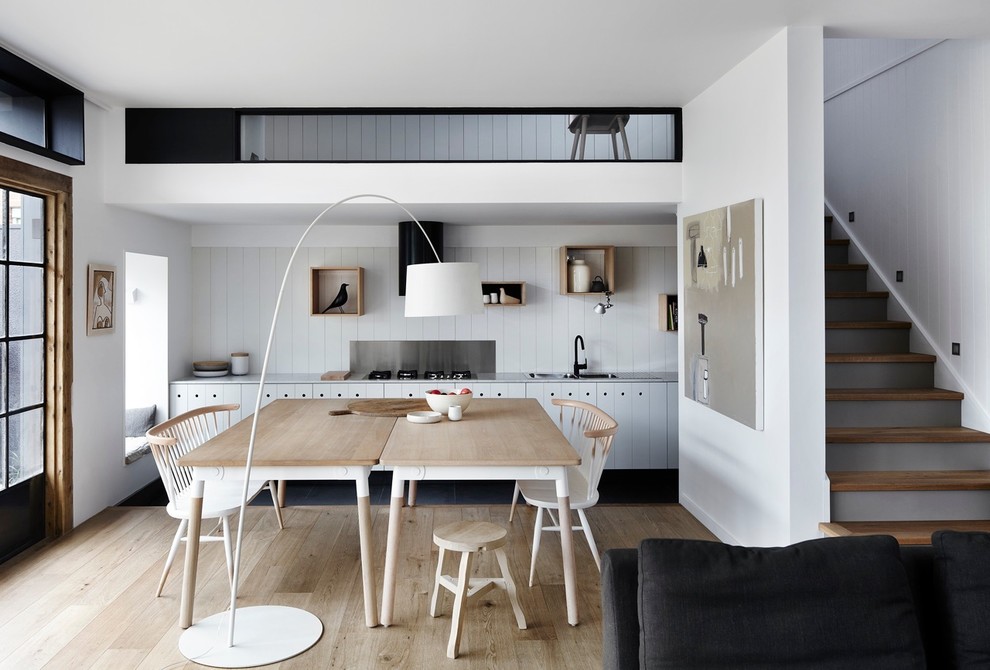Design ideas for a scandinavian open plan dining in Melbourne with white walls, light hardwood floors and beige floor.