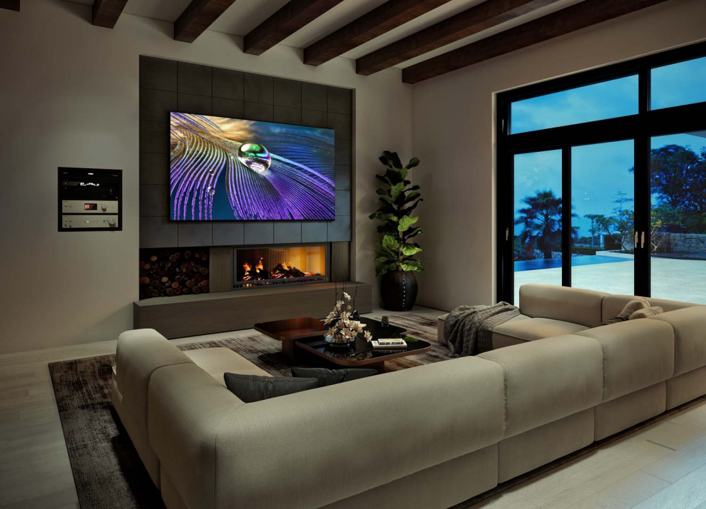 Example of a large minimalist ceramic tile, beige floor and coffered ceiling living room design in DC Metro with beige walls, a standard fireplace, a tile fireplace and a media wall