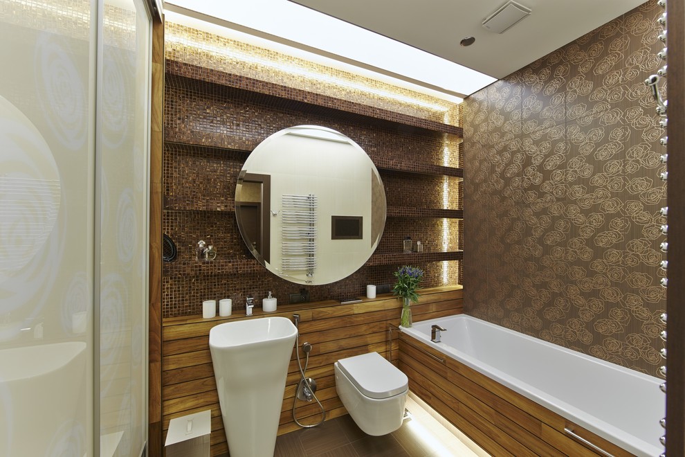 This is an example of a contemporary master bathroom in Moscow with an alcove tub, a shower/bathtub combo, a wall-mount toilet, brown tile and a pedestal sink.