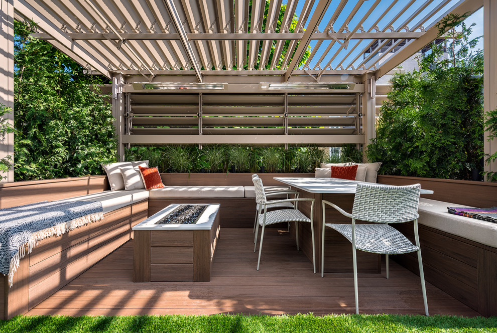 This is an example of a mid-sized modern rooftop deck in Chicago with a vertical garden and a pergola.