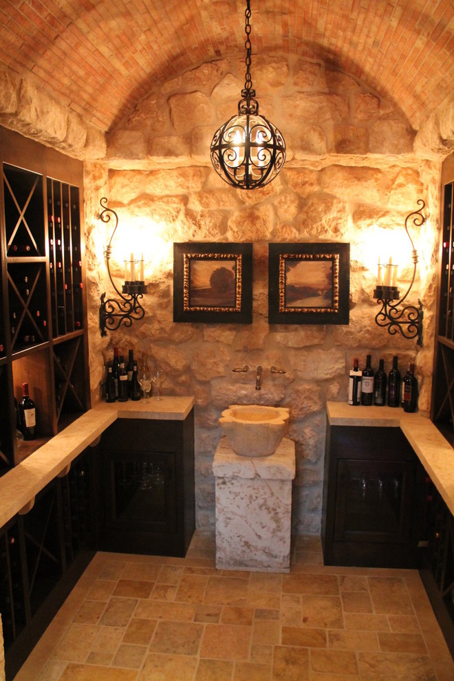 Design ideas for a mid-sized mediterranean wine cellar in Orange County with travertine floors, diamond bins and beige floor.