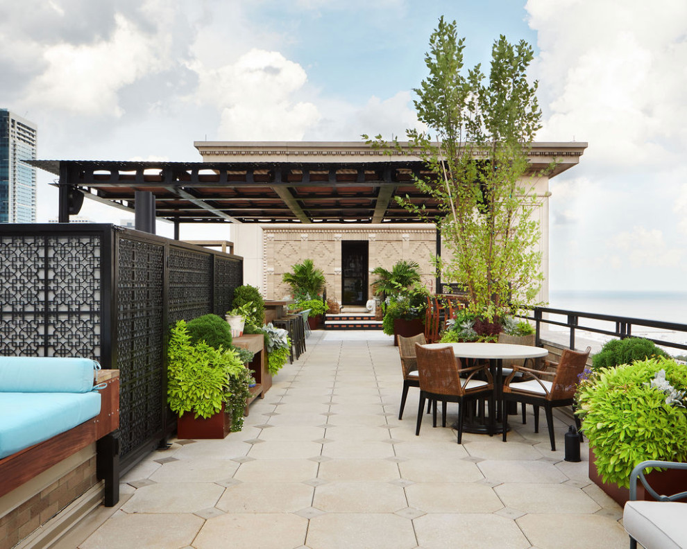 Large modern roof rooftop metal railing terrace in Chicago with a pergola and a potted garden.