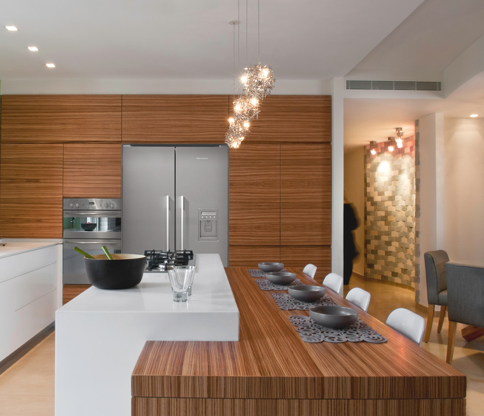 Modern eat-in kitchen in Tel Aviv with medium wood cabinets, solid surface benchtops, stainless steel appliances and flat-panel cabinets.