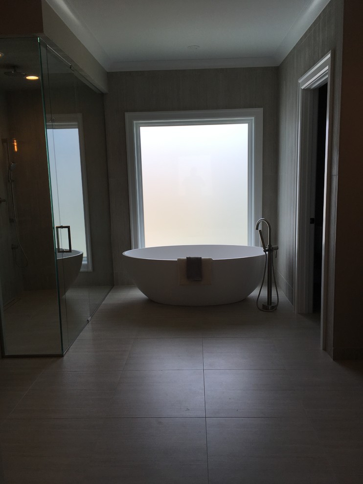 Example of a large transitional master beige tile and porcelain tile porcelain tile and beige floor home design design in Chicago with shaker cabinets, dark wood cabinets, a two-piece toilet, brown walls, an undermount sink, quartz countertops, a hinged shower door and beige countertops