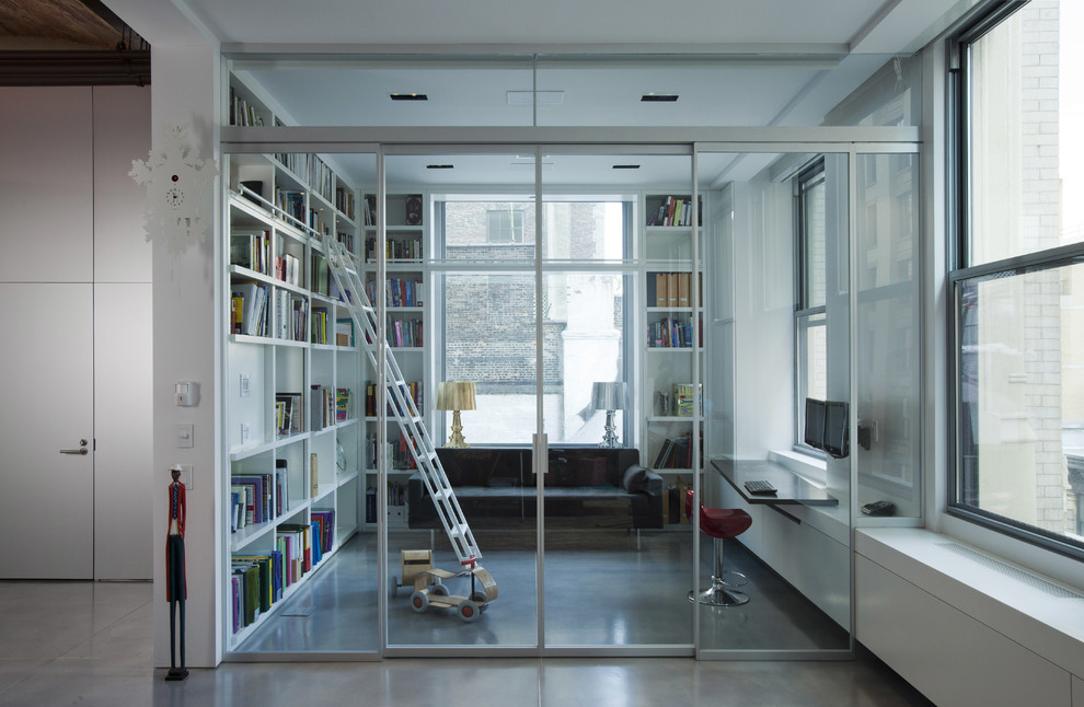 Photo of an industrial home office in New York with concrete floors.
