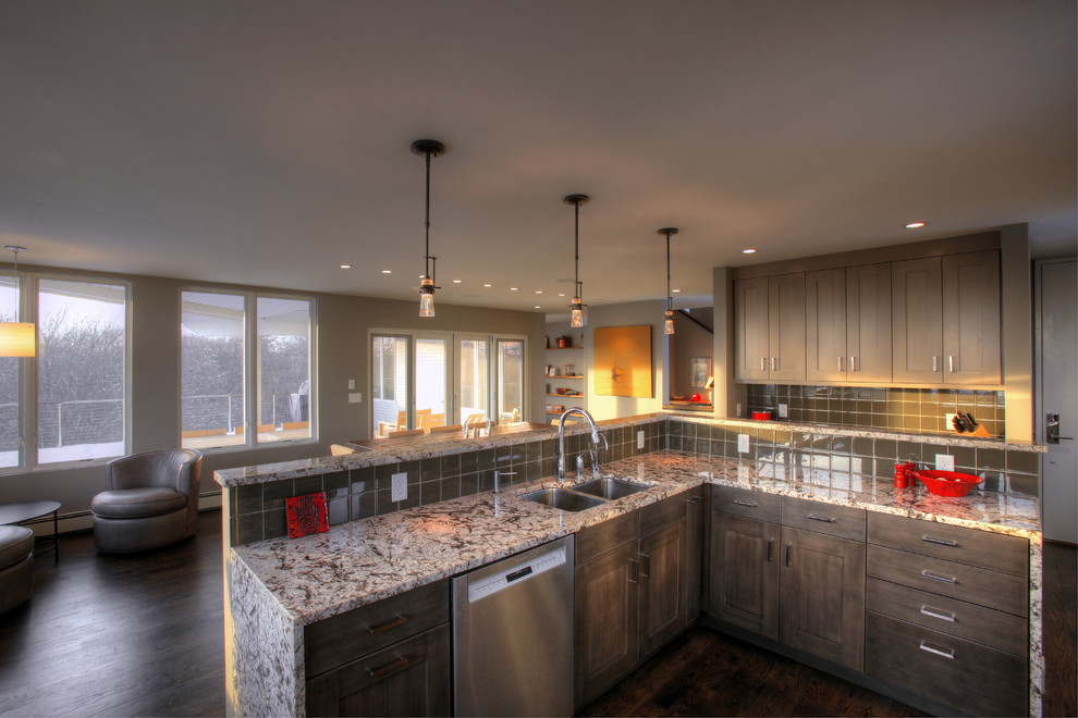 Inspiration for a large transitional u-shaped dark wood floor and brown floor eat-in kitchen remodel in Boston with a double-bowl sink, shaker cabinets, gray cabinets, granite countertops, gray backsplash, glass tile backsplash, stainless steel appliances and an island