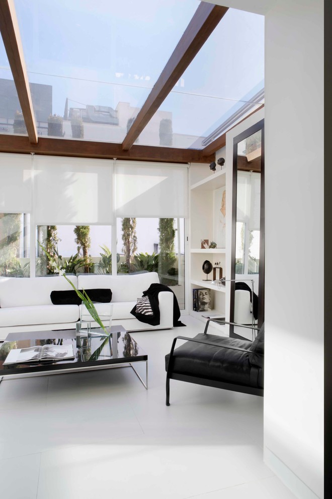 Photo of a mid-sized contemporary sunroom in Madrid with ceramic floors, no fireplace and a skylight.