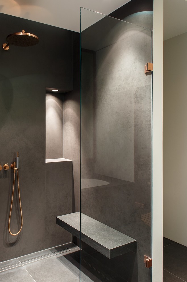 Large contemporary 3/4 bathroom in Berlin with a curbless shower, grey walls, gray tile, flat-panel cabinets, white cabinets, a drop-in tub, a two-piece toilet, limestone, limestone floors, a vessel sink, marble benchtops, grey floor and a hinged shower door.