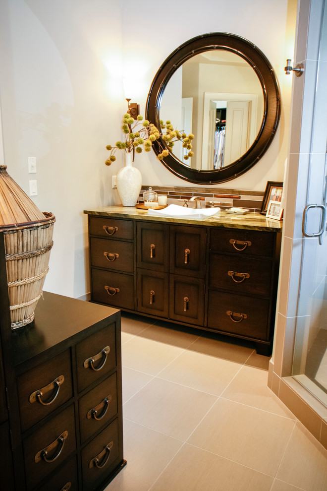 Photo of a large asian master bathroom in Other with furniture-like cabinets, dark wood cabinets, a drop-in tub, a corner shower, beige tile and beige walls.