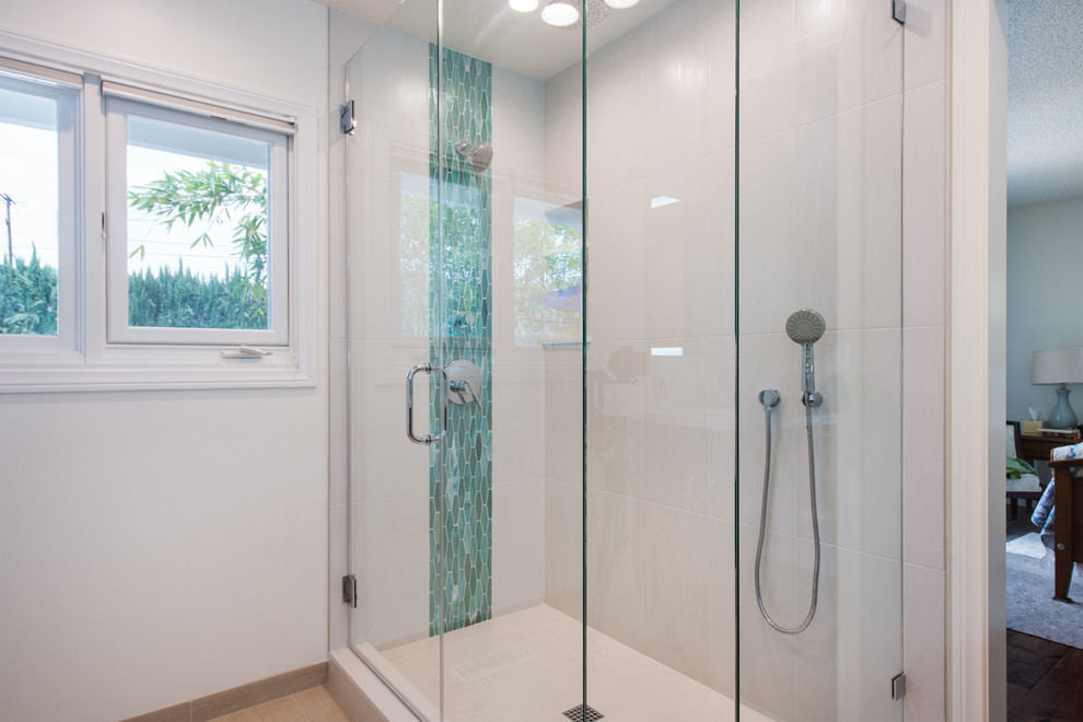 Inspiration for a mid-sized modern master bathroom in Orange County with flat-panel cabinets, medium wood cabinets, a corner shower, a bidet, multi-coloured tile, glass sheet wall, white walls, porcelain floors, an undermount sink, engineered quartz benchtops, beige floor and a sliding shower screen.