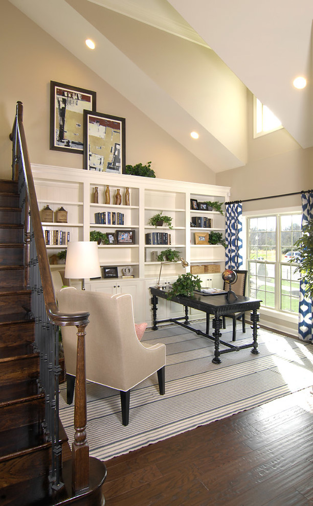 Photo of a transitional home office in Charlotte with beige walls, dark hardwood floors and a freestanding desk.