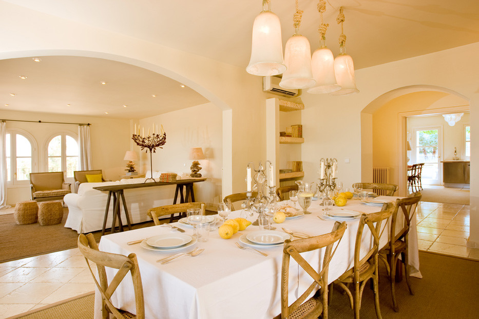 Large mediterranean open plan dining in Other with yellow walls, ceramic floors and no fireplace.